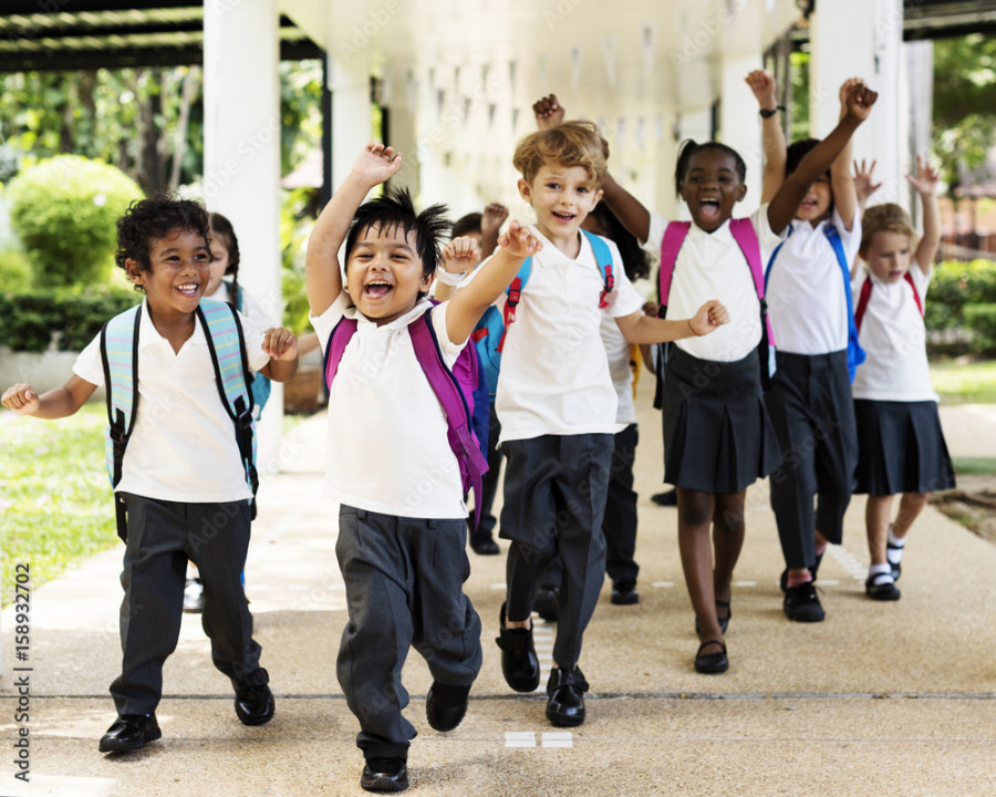 Group of diverse kindergarten students running cheerful after