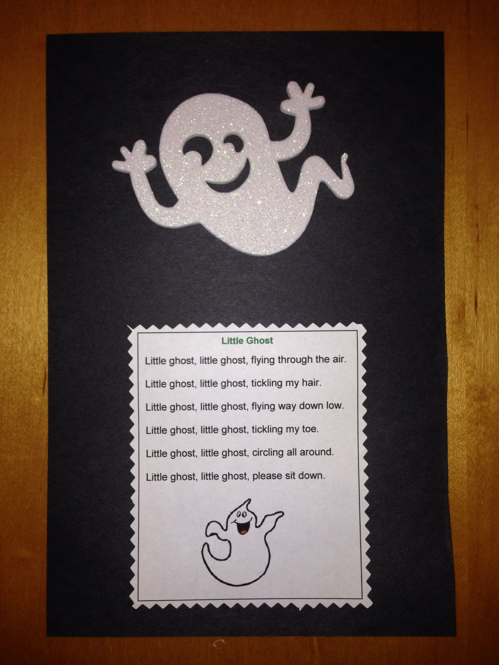 Preschool ghost craft and fun poem encouraging children to sit